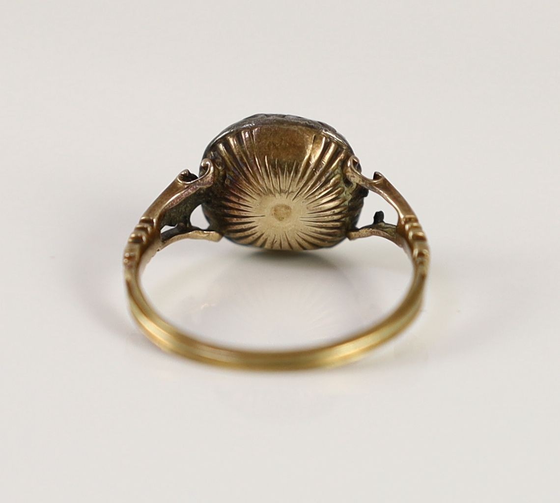 A Georgian gold, foil backed amethyst and rose cut diamond set cluster ring
